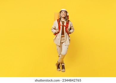 Full body smiling happy young woman carry bag with stuff mat look camera isolated on plain yellow background. Tourist leads active lifestyle walk on spare time. Hiking trek rest travel trip concept - Powered by Shutterstock