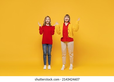 Full Body Surprised Amazed Shocked Woman 50s Teenager Girl 12-13 Years Old. Grandmother Granddaughter Spread Hands Say Wow Cool Isolated On Plain Yellow Background Studio. Family Lifestyle Concept.