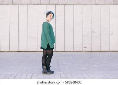 Full Body Of A Teen Androgynous Woman With Blue Dyed Hair Isolated On The Street Wearing A Blue Sweater.