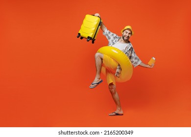 Full Body Traveler Tourist Man In Summer Clothes Hat Hold Suitcase Bag Passport Ticket Inflatable Ring Isolated On Plain Orange Background Passenger Travel Abroad On Weekend Getaway Air Flight Concept