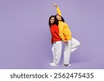 Full body two young smiling little kid teen girls women they wear red yellow hoodie casual clothes stand back to back lean dancing isolated on plain pastel light purple background. Lifestyle concept