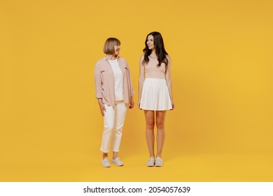 Full Body Two Young Smiling Happy Daughter Mother Together Couple Women In Casual Beige Clothes Looking To Each Other Isolated On Plain Yellow Color Background Studio Portrait Family Lifestyle Concept