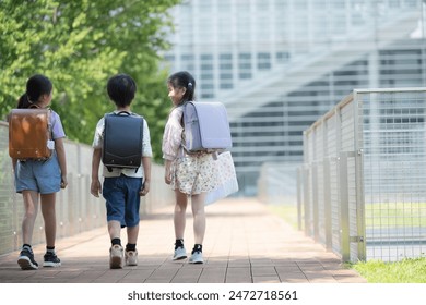 Full body without multiple faces behind school bags of elementary school students going to and from school