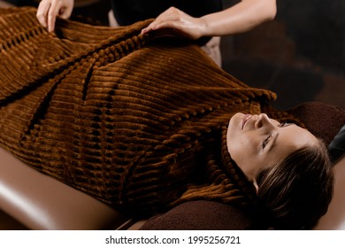 Full Body Wrap After Chocolate Massage. Beauty Treatment For Female Model In Spa