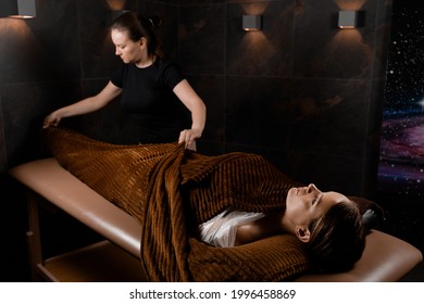 Full Body Wrap In Warm Blanket After Chocolate Massage Beauty Treatment For Female Model In Spa