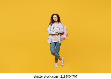 Full body young black teen girl student she wear casual clothes backpack bag hold book hands crossed folded look camera isolated on plain yellow color background High school university college concept - Powered by Shutterstock