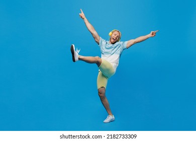 Full body young blond man with dreadlocks 20s he wear white t-shirt headphones listen to music dance with outstretched hands raise up leg isolated on plain pastel light blue background studio portrait - Powered by Shutterstock