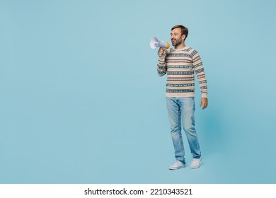 Full Body Young Caucasian Man 30s Wear Sweater Hold Scream In Megaphone Announces Discounts Sale Hurry Up Isolated On Plain Pastel Light Blue Cyan Background Studio Portrait. People Lifestyle Concept