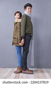 Full Body Young Couple Back To Back Standing Together Posing In Studio