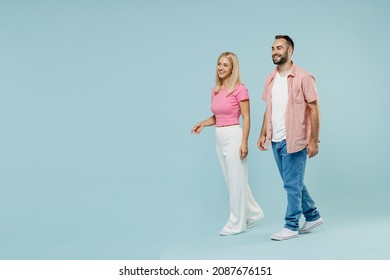 Full Body Young Couple Fun Two Friends Family Man Woman In Casual Clothes Looking Aside Walk Go Together Isolated On Pastel Plain Light Blue Color Background Studio Portrait People Lifestyle Concept