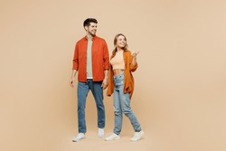 Full Body Young Couple Two Friends Family Man Woman Wear Casual Clothes Together Point Thumb Finger Aside Indicate On Workspace Area Copy Space Mock Up Isolated On Pastel Plain Beige Color Background