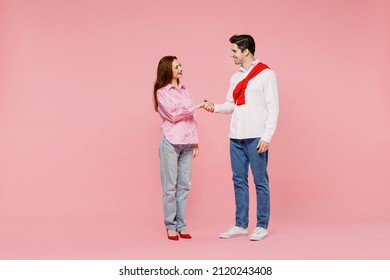 Full Body Young Couple Two Friends Woman Man In Shirt Hold Hands Folded Handshake Gesture, Isolated On Plain Pink Background. Valentine's Day Birthday Holiday Party Friendship Business Greet Concept