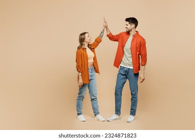 Full body young couple two friends family man woman wear casual clothes together meeting together greeting giving high five clapping hands folded isolated on pastel plain light beige color background - Powered by Shutterstock