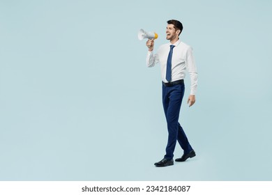 Full body young employee IT business man corporate lawyer wear classic formal shirt tie work in office hold megaphone scream announces discounts sale Hurry up isolated on plain pastel blue background - Powered by Shutterstock