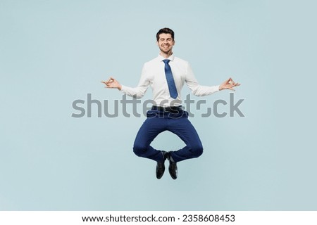 Full body young employee IT business man corporate lawyer wear classic formal shirt tie work in office spread hand in yoga om aum gesture relax meditate try calm down isolated on plain blue background