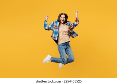 Full body young excited happy fun overjoyed woman wear blue shirt beige t-shirt jump high do winner gesture clench fists isolated on plain yellow background studio portrait. People lifestyle concept - Shutterstock ID 2254453525