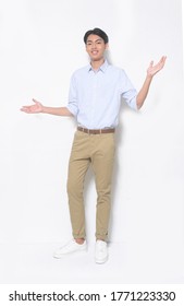 Full Body Young Handsome Man Wearing Striped Shirt With Khaki Pants And White Sneakers With Open Arms 