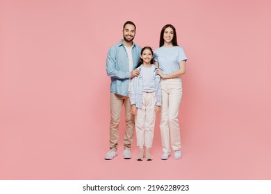 Full Body Young Happy Caucasian Smiling Fun Cool Parents Mom Dad With Child Kid Daughter Teen Girl Wearing Blue Clothes Look Camera Isolated On Plain Pastel Light Pink Background. Family Day Concept