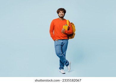 Full body young happy fun cheerful teen Indian boy student he wearing casual clothes backpack bag hold books isolated on plain pastel light blue cyan background. High school university college concept - Shutterstock ID 2335182067