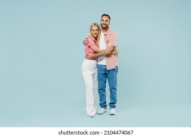 Full Body Young Happy Lovely Couple Two Friends Family Man Woman In Casual Clothes Looking Camera Hug Together Isolated On Pastel Plain Light Blue Background Studio Portrait People Lifestyle Concept.