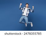 Full body young happy man he wear shirt white t-shirt casual clothes jump high doing winner gesture celebrate clenching fists isolated on plain blue cyan background studio portrait. Lifestyle concept