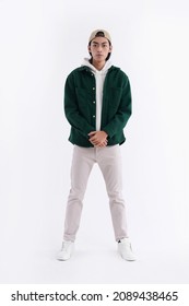 Full Body Young Man Wearing A White Hoodie With Green Shirt With Hat In Studio

