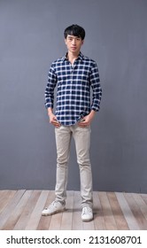 Full Body Young Man Wearing Checkered Shirt
 Paid Shirt With Khaki Pants Standing Posing In Studio
