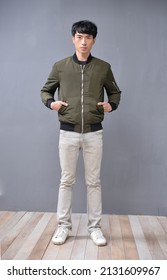 Full Body Young Man Wearing Jacket With Khaki Pants Standing Posing In Studio