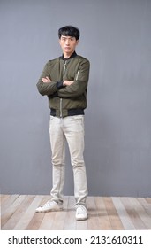 Full Body Young Man Wearing Jacket With Khaki Pants Standing Posing In Studio