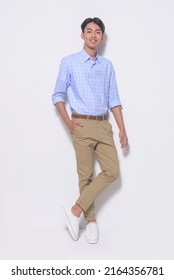 Full Body Young Man Wearing Striped Shirt With Khaki Pants Standing In Studio