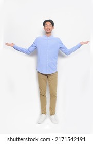 Full Body Young Man Wearing Blue Shirt With Khaki Pants  Open Hands Standing In Studio