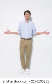 Full Body Young Man Wearing Striped Shirt With Khaki Pants Open Hands Standing In Studio