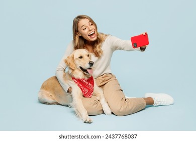 Full body young owner woman with her best friend retriever dog wears casual clothes doing selfie shot on mobile cell phone isolated on plain light blue background studio. Take care about pet concept - Powered by Shutterstock