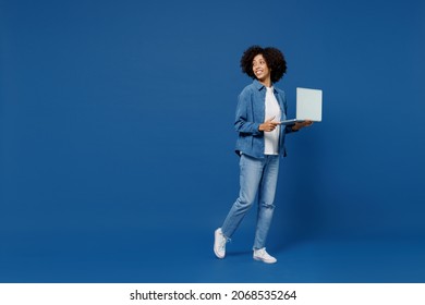 Full Body Young Smiling Happy Black Woman In Casual Clothes Shirt White T-shirt Hold Use Work On Laptop Pc Computer Look Aside Isolated On Plain Dark Blue Background Studio. People Lifestyle Concept