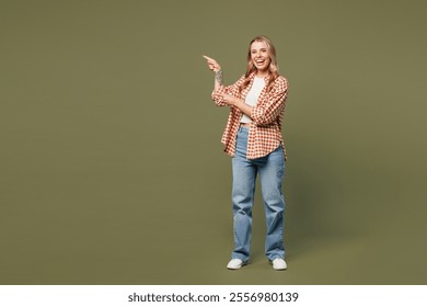 Full body young smiling happy woman wear red shirt white t-shirt casual clothes point index finger aside on area mock up isolated on plain pastel green background studio portrait. Lifestyle concept - Powered by Shutterstock