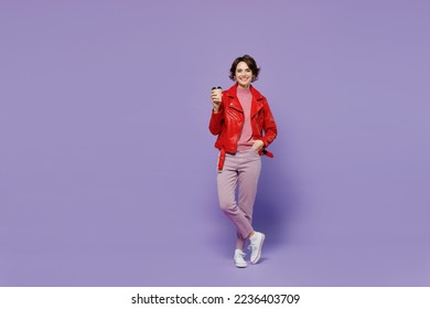 Full body young smiling satisfied happy woman 20s wear red leather jacket hold takeaway delivery craft paper brown cup coffee to go isolated on plain pastel light purple background studio portrait. - Powered by Shutterstock