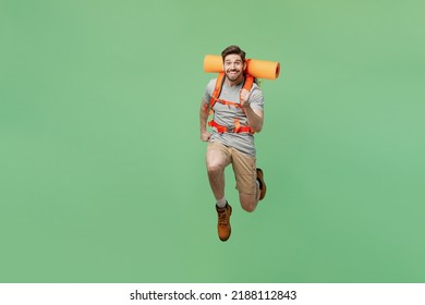 Full body young strong traveler white man carry backpack stuff mat walk jump high run isolated on plain green background. Tourist leads active healthy lifestyle. Hiking trek rest travel trip concept - Powered by Shutterstock