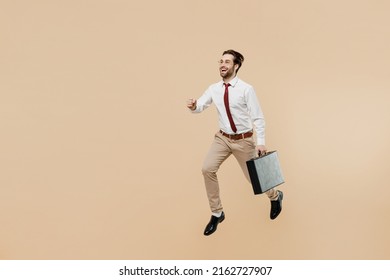 Full Body Young Successful Employee Business Man Corporate Lawyer 20s Wear White Shirt Red Tie Glasses Work In Office Jump Run Fast Hold Briefcase Isolated On Plain Beige Background Studio Portrait