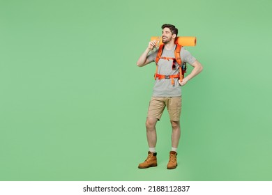 Full body young traveler white man carry backpack stuff mat walk drink water takes break isolated on plain green background Tourist leads active healthy lifestyle. Hiking trek rest travel trip concept - Powered by Shutterstock