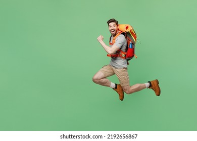 Full body young traveler white man carry backpack stuff jump do winner gesture isolated on plain green background Tourist lead active lifestyle walk on spare time Hiking trek rest travel trip concept - Shutterstock ID 2192656867