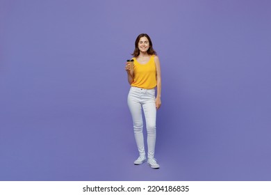 Full Body Young Woman 20s She Wear Yellow Tank Shirt Hold Takeaway Delivery Craft Paper Brown Cup Coffee To Go Isolated On Plain Pastel Light Purple Background Studio Portrait People Lifestyle Concept