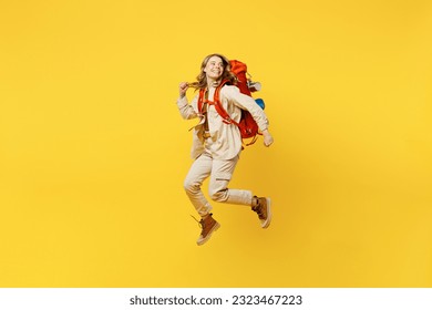 Full body young woman carry bag with stuff mat jump high look aside on area isolated on plain yellow background. Tourist leads active lifestyle walk on spare time. Hiking trek rest travel trip concept - Shutterstock ID 2323467223