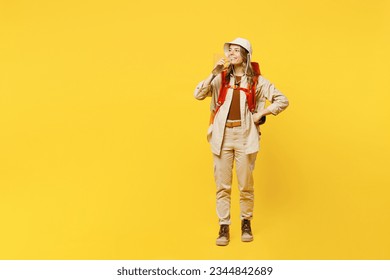 Full body young woman carry bag with stuff mat hold drink fresh pure water isolated on plain yellow background. Tourist leads active lifestyle walk on spare time. Hiking trek rest travel trip concept - Shutterstock ID 2344842689