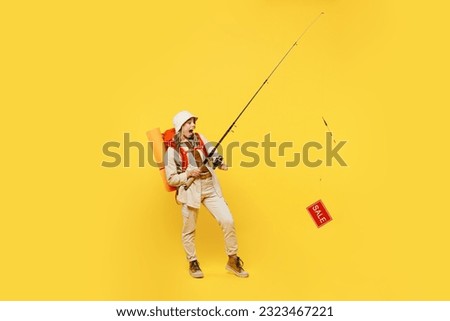 Full body young woman carry bag stuff mat holding fishing rod with sale text isolated on plain yellow background. Tourist leads active lifestyle walk on spare time Hiking trek rest travel trip concept