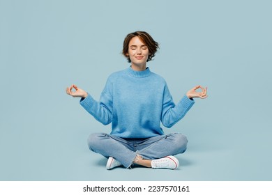 Full body young woman wear knitted sweater holding spreading hands in yoga om aum gesture relax meditate try to calm downisolated on plain pastel light blue cyan background. People lifestyle concept - Shutterstock ID 2237570161