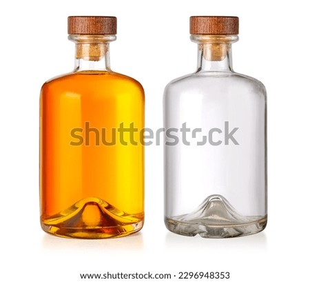 A full bottle of whiskey and empty  isolated on a white background 
