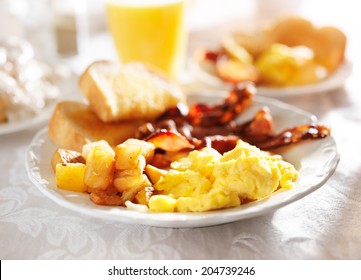 Full Breakfast With Scrambled Eggs, Fried Potatoes And Bacon,