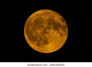 Full Buck moon glowing orange due to atmospheric conditions over Ottawa, Canada, July 21, 2024 against a black background. - Powered by Shutterstock