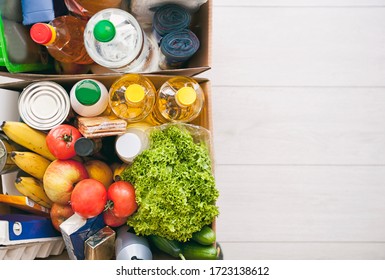 The Full Cardboard Eco Box With Products From The Grocery Store On The Floor At Home