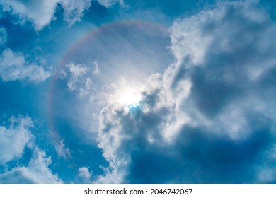 Full Circle Rainbow Or Halo Around The Sun On The Cloudy Blue Sky